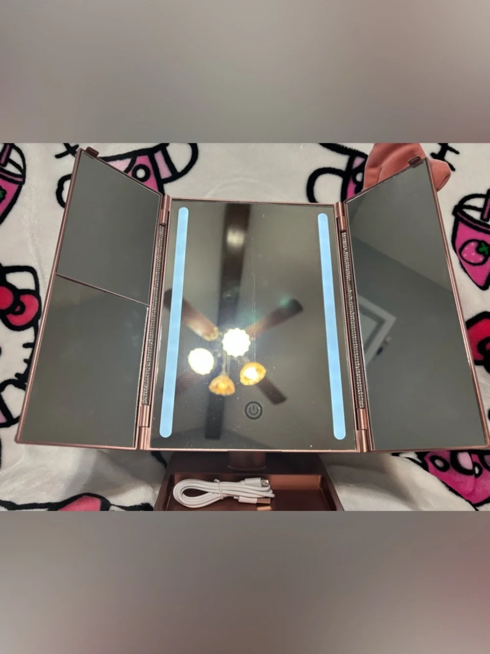 Pink trifold makeup mirror with lights